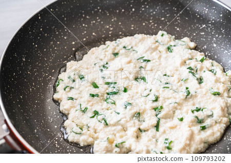 Tofu pancake dough baked in a frying pan 109793202