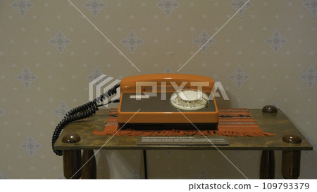 Old Soviet orange disk phone. Od phone in the Museum of history Old Soviet orange disk phone. Od phone in the Museum of history 109793379