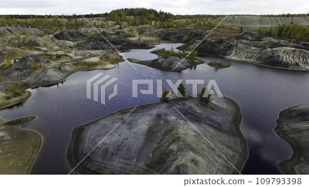 Small lake, top view. Footage. A small lake in a mountainous area. Panoramic view over the rocky mountain tops around Lake 109793398