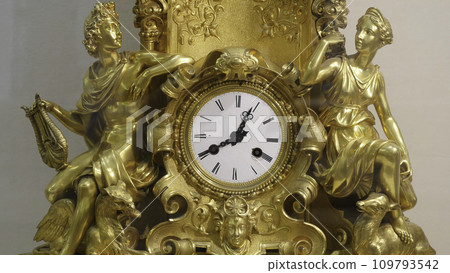 Ancient vintage brass pendulum clock. Vintage gold watch Ancient vintage brass pendulum clock. Vintage gold watch 109793542