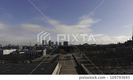Aerial view of Linnahall, district in Tallinn, Estonia. Stock. Flying over the venue with a walking man on blue cloudy sky and the city with skyscrapers background. Aerial view of Linnahall, district in Tallinn, Estonia. Stock. Flying over the venue with a walking man on blue cloudy sky and the city with skyscrapers background. 109793693