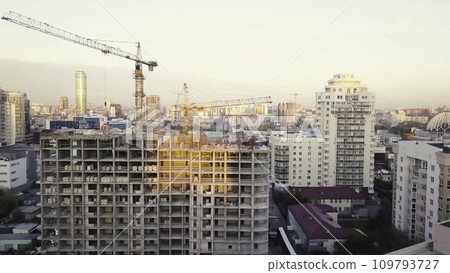 Construction site with cranes. Video. Construction workers are building. Aerial view. Top view of the construction site in the city. Construction in the city with a crane manipulator 109793727