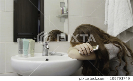 Woman crying in the bathroom after a quarrel with her husband, her husband calms 109793749