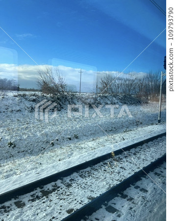 Beautiful winter landscape with snow-covered fields and blue sky. Railway tracks in the snow. Winter landscape with snow and blue sky 109793790