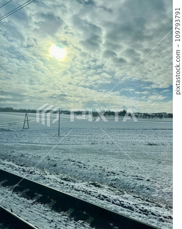 Beautiful winter landscape with snow-covered fields and blue sky. Railway tracks in the snow. Winter landscape with snow and blue sky 109793791