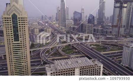 View on modern skyscrapers and busy evening highways day in luxury downtown of Dubai city. Top aerial view from tower rooftop. Road junction traffic. Beautiful daytime cityscape of downtown Dubai 109793930