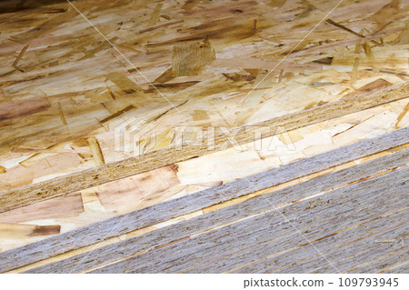stacks of tongue and groove OSB compressed sawdust sheets 109793945
