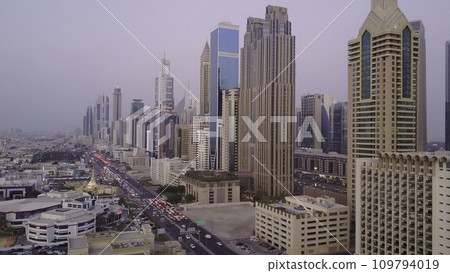 View on modern skyscrapers and busy evening highways day in luxury downtown of Dubai city. Top aerial view from tower rooftop. Road junction traffic. Beautiful daytime cityscape of downtown Dubai 109794019