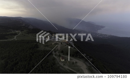 Bay of the sea, mountains, rocks, embankment and city buildings at the sunset aerial view. Shot. Aerial of sunset. Aerial shot of amazing mountains and rocks on a seashore Bay of the sea, mountains, rocks, embankment and city buildings at the sunset aerial view. Shot. Aerial of sunset. Aerial shot of amazing mountains and rocks on a seashore 109794180