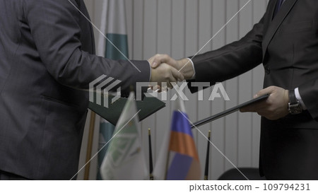 Two businessman with made a deal. Two businessmen shaking hands indicating successfully made deal 109794231