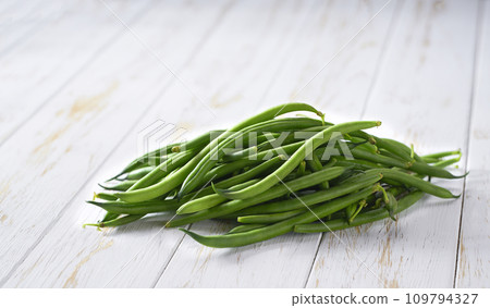 fresh green beans on a wooden table, selective focus. fresh green beans on a wooden table, selective focus. 109794327
