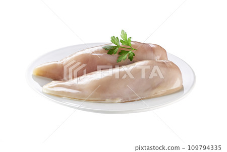 two fresh raw chicken breasts and parsley in a plate isolated on white background. two fresh raw chicken breasts and parsley in a plate isolated on white background. 109794335