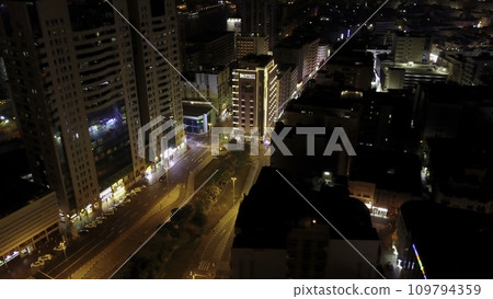 Elevated illuminated night view of Media and Internet city skyscrapers on Sheikh Zayed Road downtown, Dubai, UAE. Scenic aerial view of a big modern city at night. Business bay, Dubai, United Arab 109794359