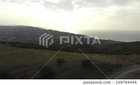 Aerial View. Shot. Flying over the high mountains in beautiful clouds Aerial View. Shot. Flying over the high mountains in beautiful clouds 109794444