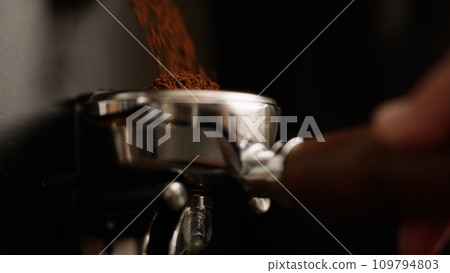 closeup of fresh ground coffee fall in portafilter 109794803