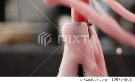 closeup open a bottle of berry soft drink which is over pressured and make a fountain 109794808