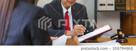 Legal and justice concept, Senior lawyer pointing on contract and discussing with female lawyer Legal and justice concept, Senior lawyer pointing on contract and discussing with female lawyer 109794868