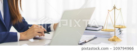 Lawyer woman reading business contract and checking document about legal agreement in legal office Lawyer woman reading business contract and checking document about legal agreement in legal office 109794966