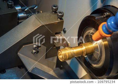 Close up scene the CNC lathe machine slot cutting at the end of brass pipe coupling parts. Close up scene the CNC lathe machine slot cutting at the end of brass pipe coupling parts. 109795234