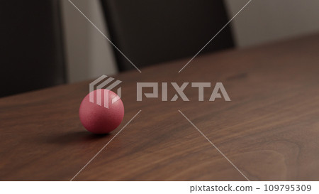 spinning easter egg on walnut table 109795309