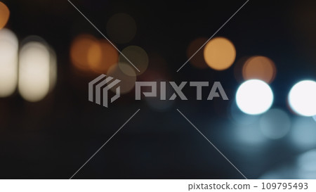 Bokeh background of night city with car light passing by Bokeh background of night city with car light passing by 109795493