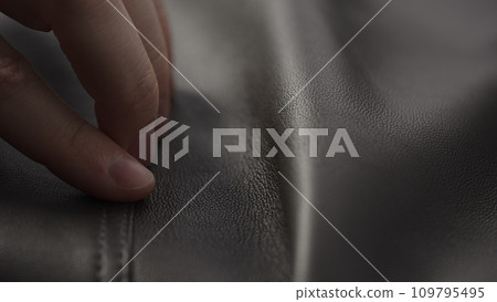 Closeup man touching fine leather Closeup man touching fine leather 109795495