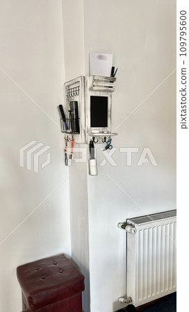 Wooden organizer in the hallway with accessories for use as a decorative element 109795600