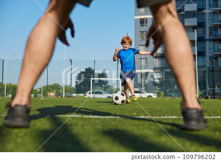 Father and son organizing family football summer camp at city stadium Father and son organizing family football summer camp at city stadium 109796202