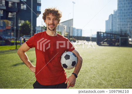 Portrait of happy male football trainer or soccer player with sweaty face 109796210