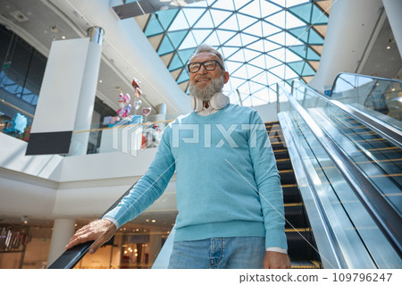 Happy fashion elderly man with purchases s in shopping mall Happy fashion elderly man with purchases s in shopping mall 109796247