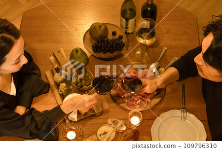 A couple toasting with wine A couple toasting with wine 109796310