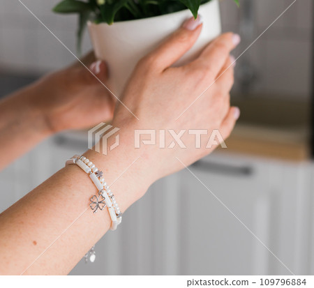 Close-up woman wearing beautiful luxury bracelets. Handmade jewellery and accessories 109796884