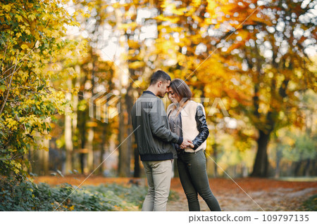 lovely couple walking around the park during autumn lovely couple walking around the park during autumn 109797135