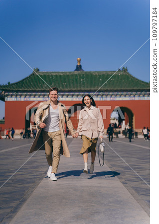 lovely couple exploring tourist attractions in Beijing China. Couple exploring temple of heaven in Beijing China. Couple experiencing chinese culture and architecture. 109797184