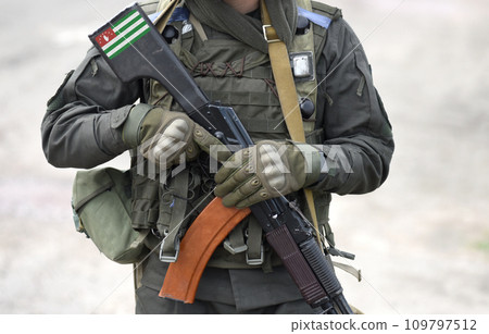 Flag of Republic of Abkhazia on submachine gun butt. Military,  armed forces, soldiers. Collage. 109797512