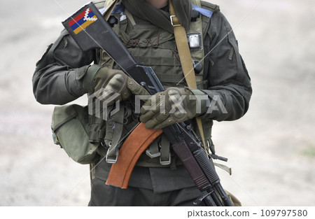 Flag of Artsakh on submachine gun butt. Republic of Artsakh and also known as Nagorno-Karabakh Republic. Military Conflict in the Caucasus. Collage. Flag of Artsakh on submachine gun butt. Republic of Artsakh and also known as Nagorno-Karabakh Republic. Military Conflict in the Caucasus. Collage. 109797580
