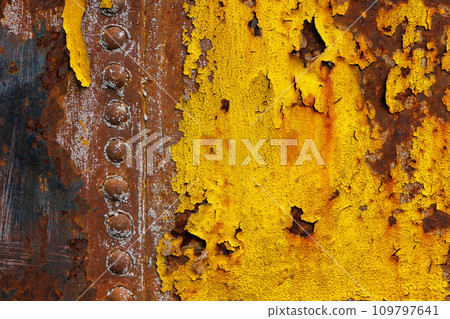 beautifully rusted rivetted sheet metal with leftovers of yellow paint texture and full-frame background 109797641