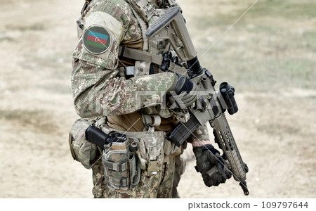 Soldier with machine gun and flag of Azerbaijan on military uniform. Collage. 109797644