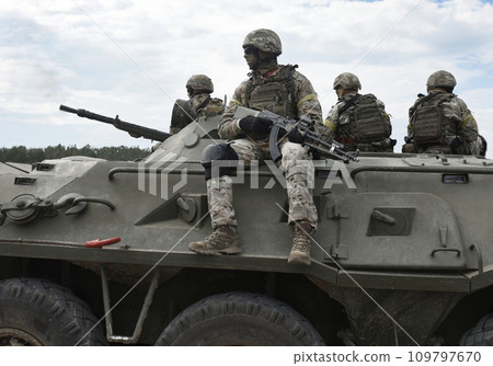 Soldiers with machine guns on an armored personnel carrier. Post-Soviet conflicts. Caucasus war Soldiers with machine guns on an armored personnel carrier. Post-Soviet conflicts. Caucasus war 109797670