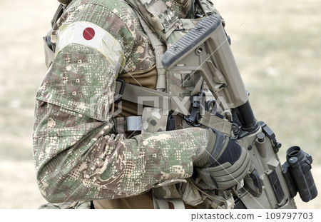 Soldier with assault rifle and flag of Japan on military uniform. Collage. 109797703
