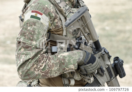 Soldier with assault rifle and flag of Kurdistan on military uniform. Collage. Soldier with assault rifle and flag of Kurdistan on military uniform. Collage. 109797726