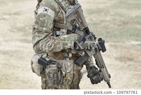Soldier with assault rifle and flag of South Korea on military uniform. Collage. Soldier with assault rifle and flag of South Korea on military uniform. Collage. 109797761