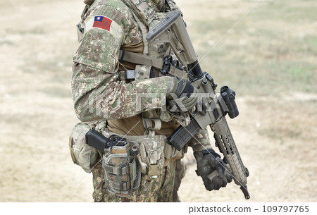 Soldier with assault rifle and flag of Taiwan on military uniform. Collage. 109797765