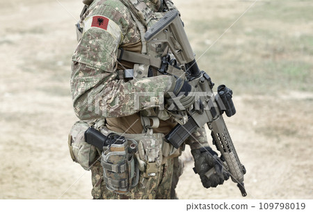 Soldier with assault rifle and flag of Albania on military uniform. Collage. 109798019