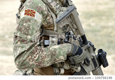 Soldier with assault rifle and flag of North Macedonia on military uniform. Collage. 109798196