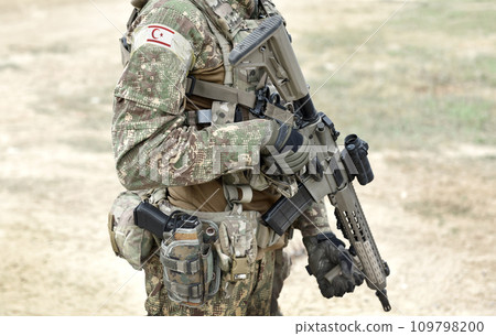 Soldier with assault rifle and flag of Northern Cyprus on military uniform. Collage. 109798200