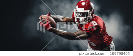 a football player catching a ball a football player catching a ball 109798405
