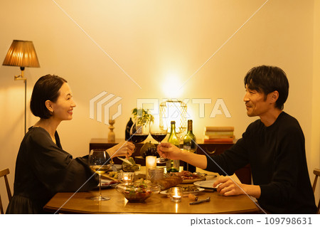 A couple making a toast with red wine 109798631