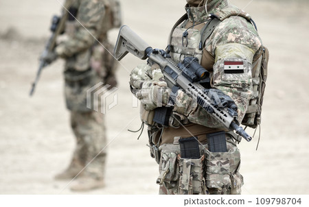 Soldiers with machine gun and flag of Syria on military uniform. Collage. Soldiers with machine gun and flag of Syria on military uniform. Collage. 109798704
