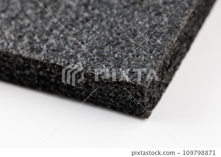 Black high-impact closed-cell polyethylene black foam sheet on white background. Specifically designed packing material. Black high-impact closed-cell polyethylene black foam sheet on white background. Specifically designed packing material. 109798871
